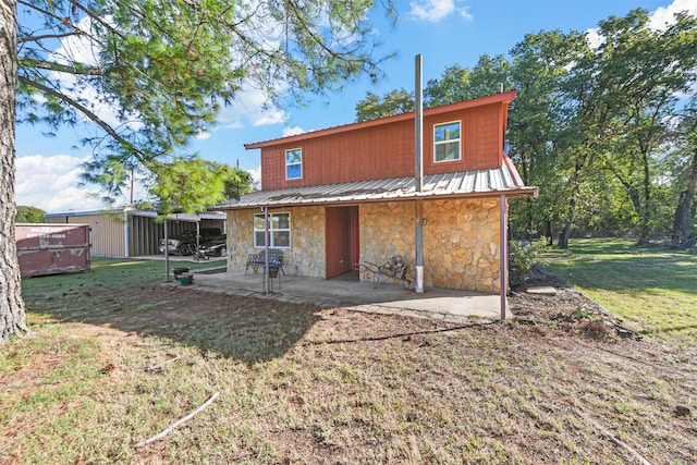 rear view of house with a yard and a patio area