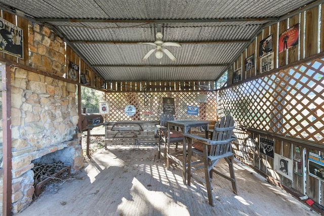 view of patio with a fireplace and ceiling fan