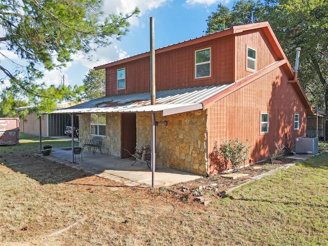 rear view of house featuring a yard, a patio, and central AC unit