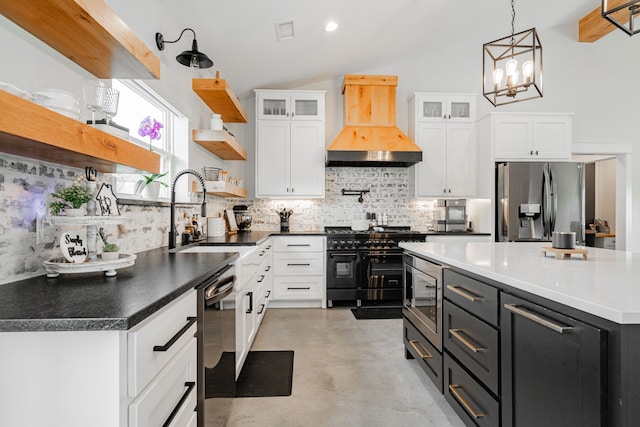 kitchen with open shelves, custom range hood, appliances with stainless steel finishes, white cabinets, and a sink