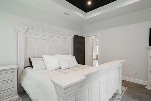 bedroom featuring visible vents, recessed lighting, a raised ceiling, and baseboards