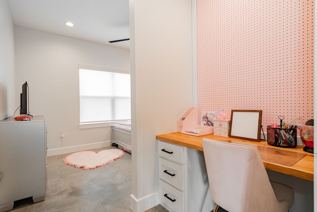 office featuring built in desk, recessed lighting, concrete flooring, and baseboards