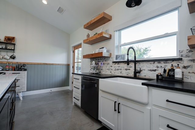 kitchen with open shelves, a sink, concrete flooring, wainscoting, and dishwasher