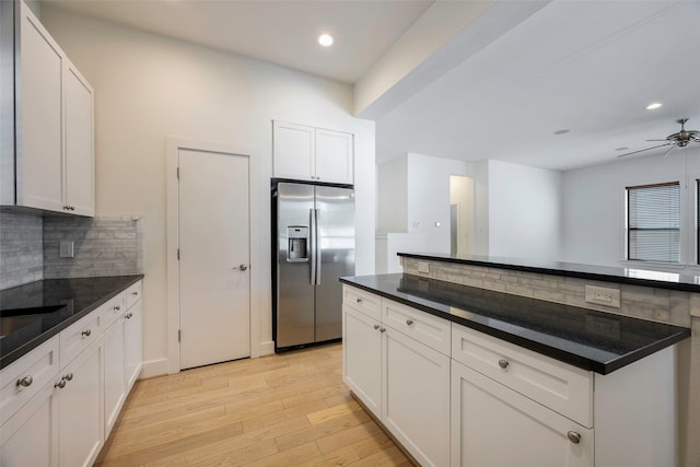 kitchen featuring white cabinetry, backsplash, ceiling fan, light hardwood / wood-style floors, and stainless steel refrigerator with ice dispenser