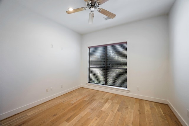 spare room with ceiling fan and light wood-type flooring