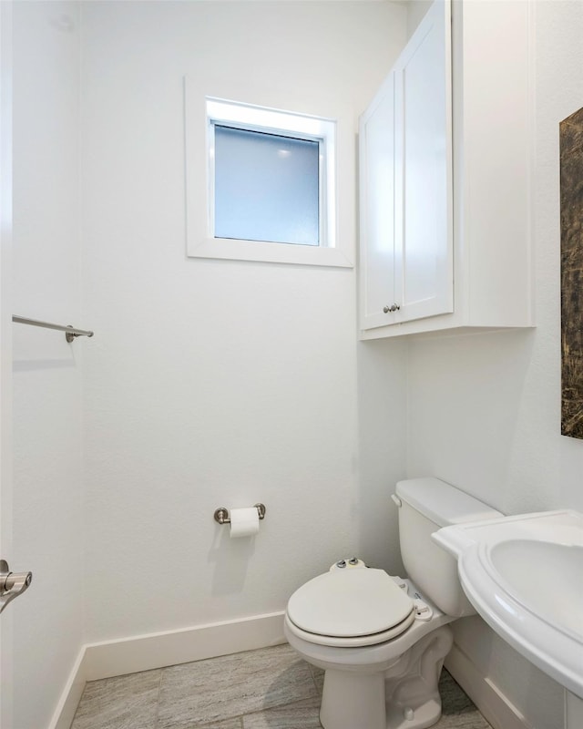 bathroom with wood-type flooring, sink, and toilet