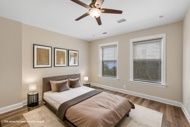 bedroom featuring dark hardwood / wood-style flooring and ceiling fan