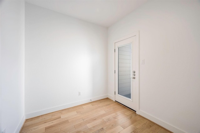 empty room with light hardwood / wood-style flooring