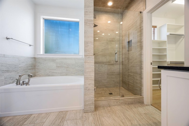 bathroom with shower with separate bathtub