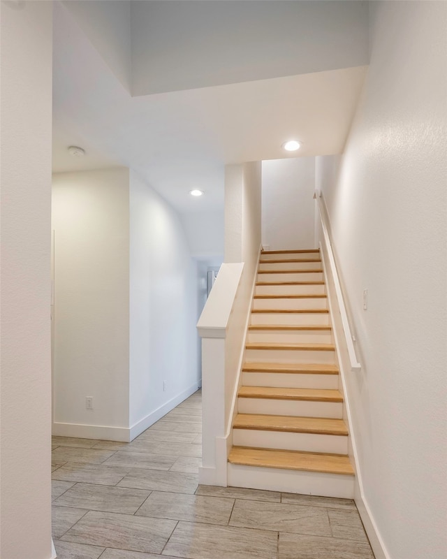 stairs with hardwood / wood-style floors