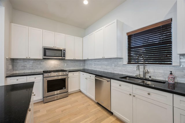 kitchen featuring white cabinetry, appliances with stainless steel finishes, and sink