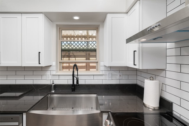 kitchen featuring ventilation hood, decorative backsplash, and white cabinetry