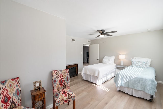 bedroom with ceiling fan and light hardwood / wood-style flooring