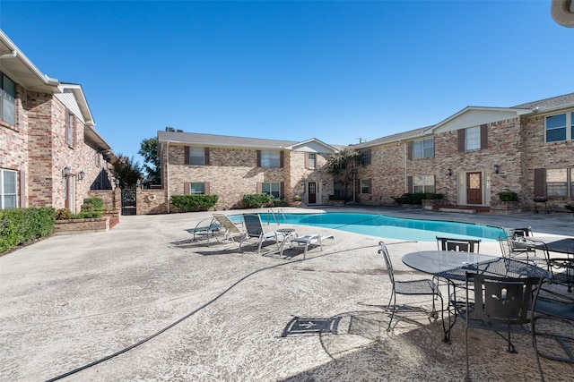 view of swimming pool with a patio