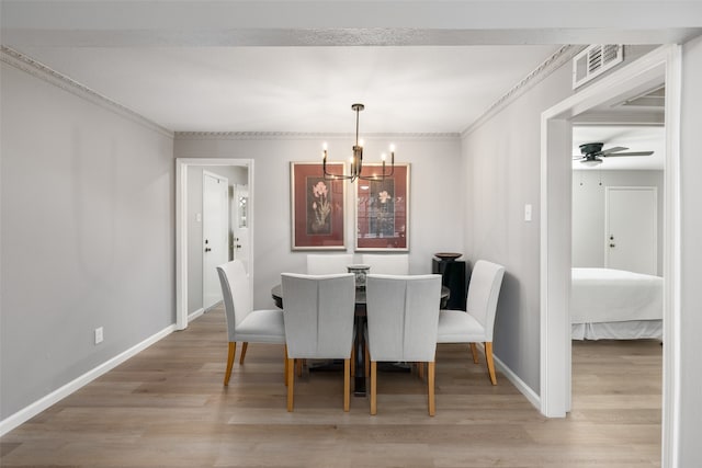 dining room featuring crown molding, wood-type flooring, and ceiling fan with notable chandelier