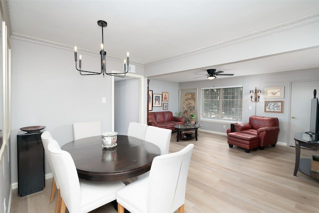 dining space with ceiling fan with notable chandelier, light wood-type flooring, and crown molding