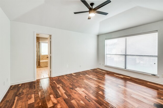 unfurnished room featuring ceiling fan, vaulted ceiling, and wood-type flooring