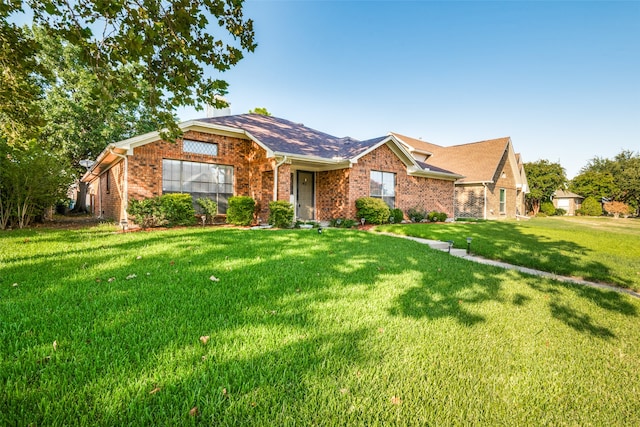 single story home featuring a front lawn