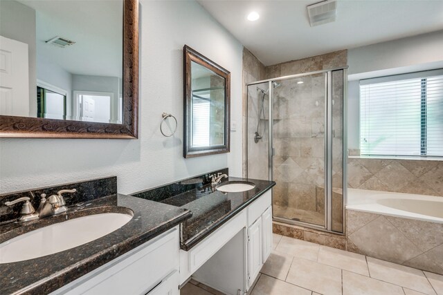 bathroom featuring vanity, tile patterned floors, and separate shower and tub