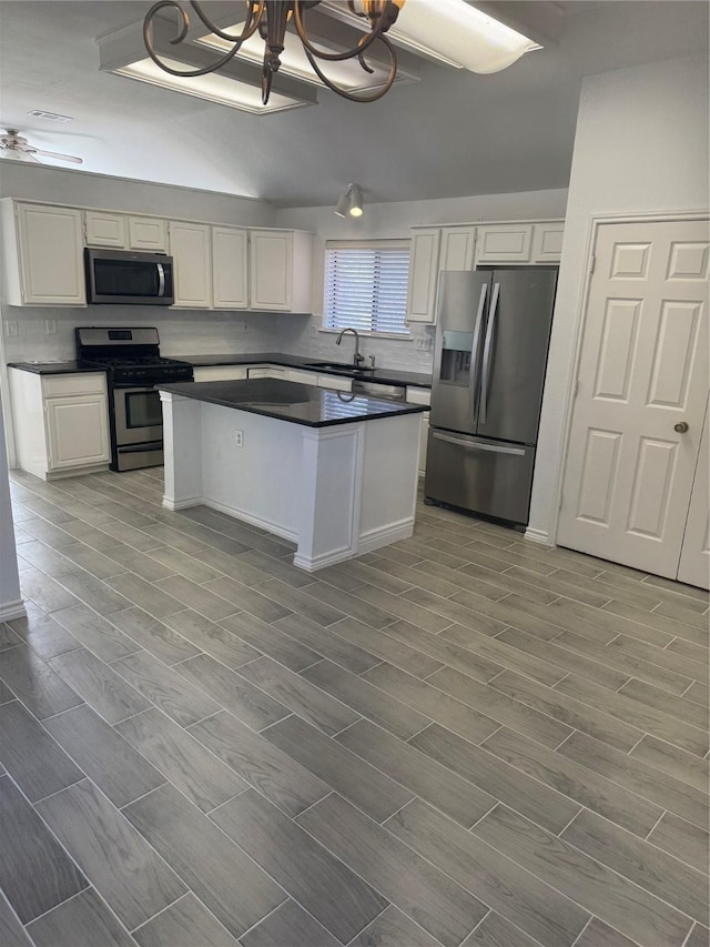 kitchen featuring sink, white cabinetry, backsplash, and appliances with stainless steel finishes