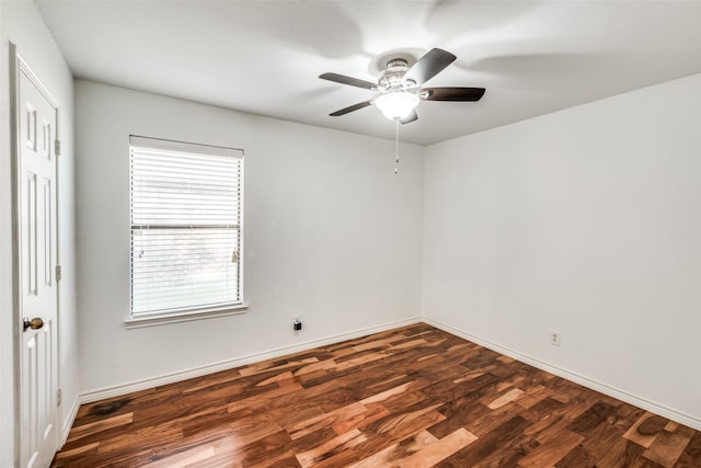 unfurnished room with dark hardwood / wood-style flooring and ceiling fan