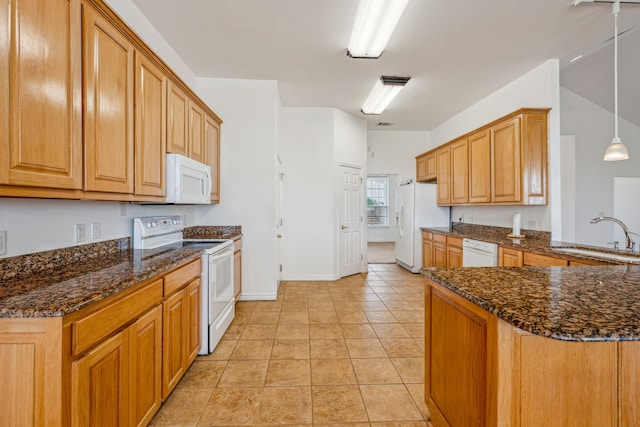 kitchen with kitchen peninsula, white appliances, sink, pendant lighting, and dark stone countertops