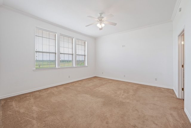 empty room with light colored carpet, ceiling fan, and crown molding