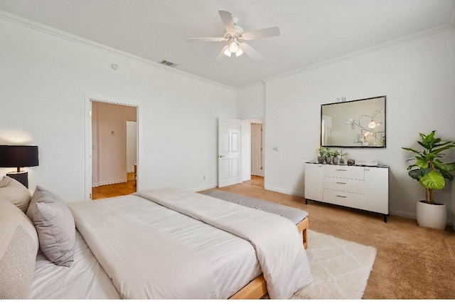 bedroom featuring light carpet, ceiling fan, and crown molding