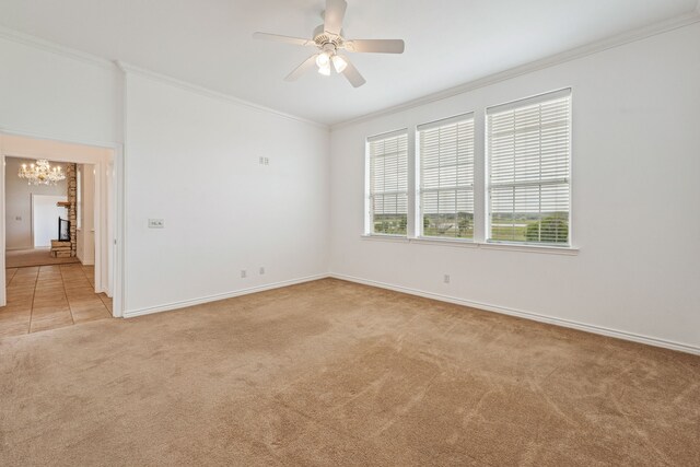 carpeted empty room featuring ceiling fan and ornamental molding