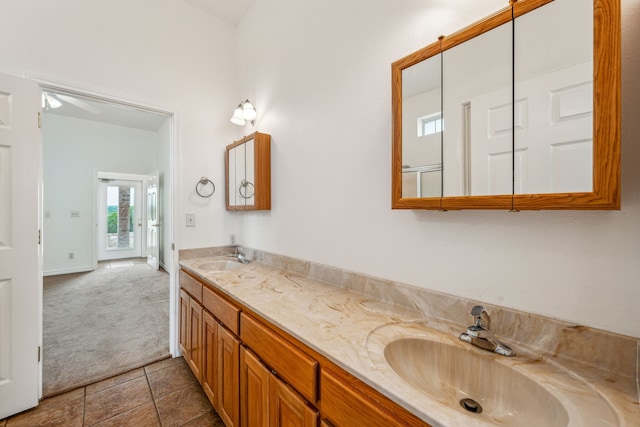 bathroom featuring tile patterned floors, ceiling fan, and vanity