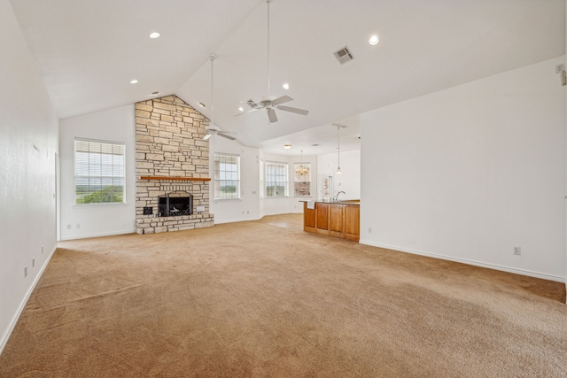 unfurnished living room featuring a fireplace, ceiling fan with notable chandelier, light colored carpet, and high vaulted ceiling