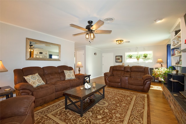 living room with ceiling fan, wood-type flooring, and ornamental molding