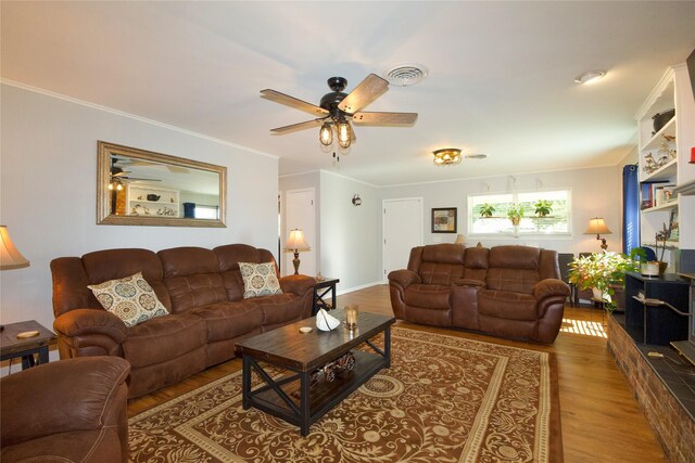 living room with ceiling fan, wood-type flooring, and ornamental molding