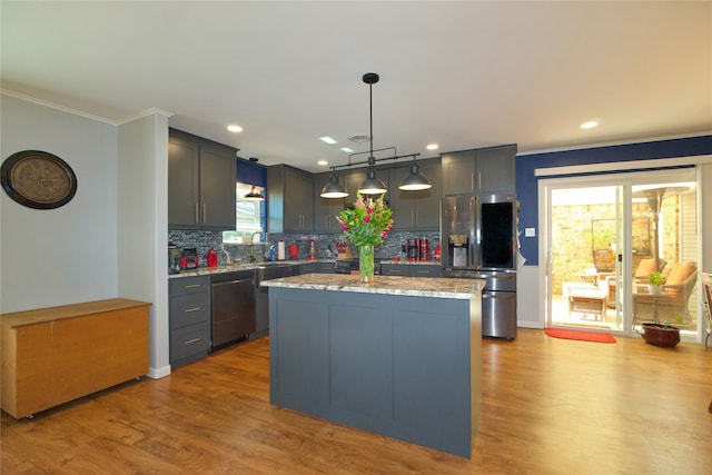 kitchen featuring decorative light fixtures, stainless steel fridge with ice dispenser, black dishwasher, light hardwood / wood-style floors, and a kitchen island