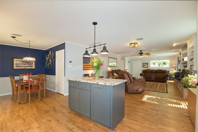 kitchen with a center island, ceiling fan, light hardwood / wood-style floors, and hanging light fixtures