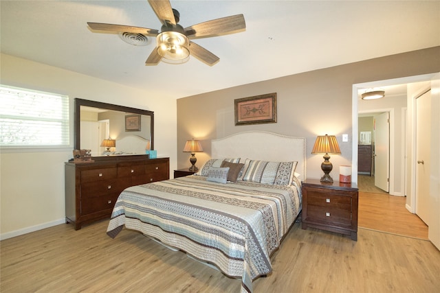 bedroom with light hardwood / wood-style flooring and ceiling fan