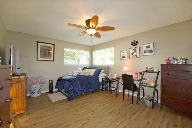 bedroom with light hardwood / wood-style flooring and ceiling fan