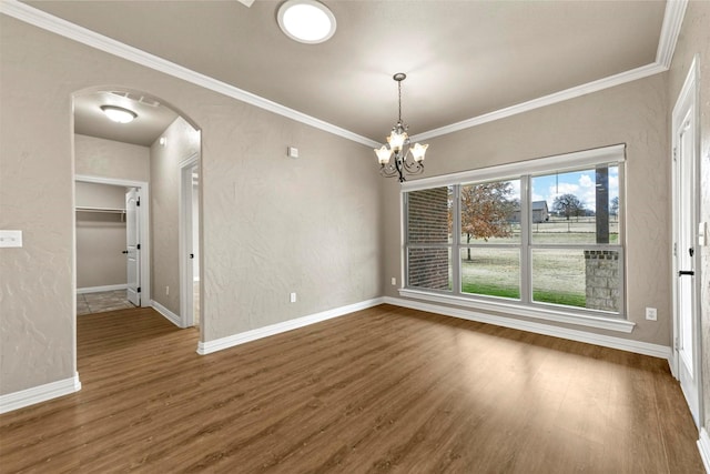 unfurnished dining area with a notable chandelier, crown molding, and dark wood-type flooring