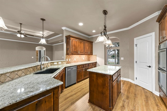 kitchen with light hardwood / wood-style floors, ornamental molding, sink, and appliances with stainless steel finishes