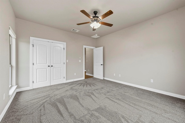 unfurnished bedroom featuring ceiling fan, a closet, and dark carpet