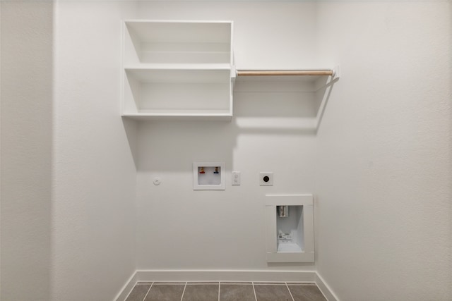 laundry area with hookup for a washing machine, dark tile patterned floors, gas dryer hookup, and electric dryer hookup