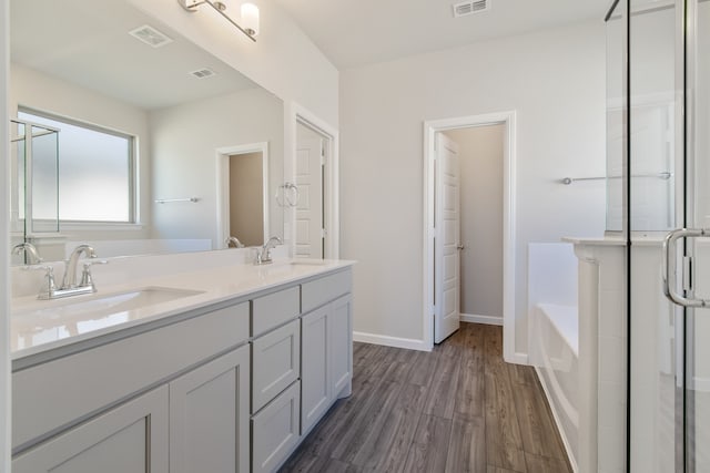 bathroom featuring vanity, shower with separate bathtub, and hardwood / wood-style flooring