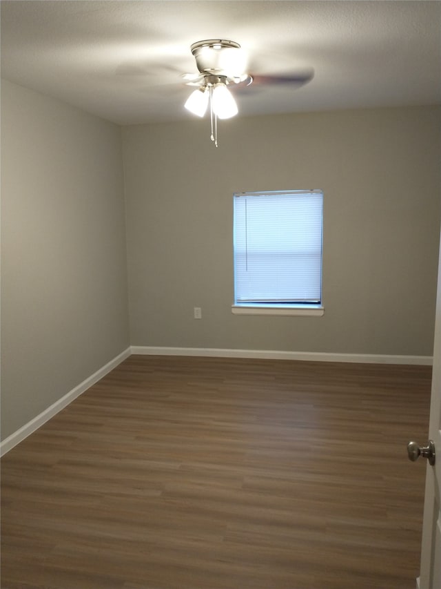 unfurnished room featuring ceiling fan and dark hardwood / wood-style floors