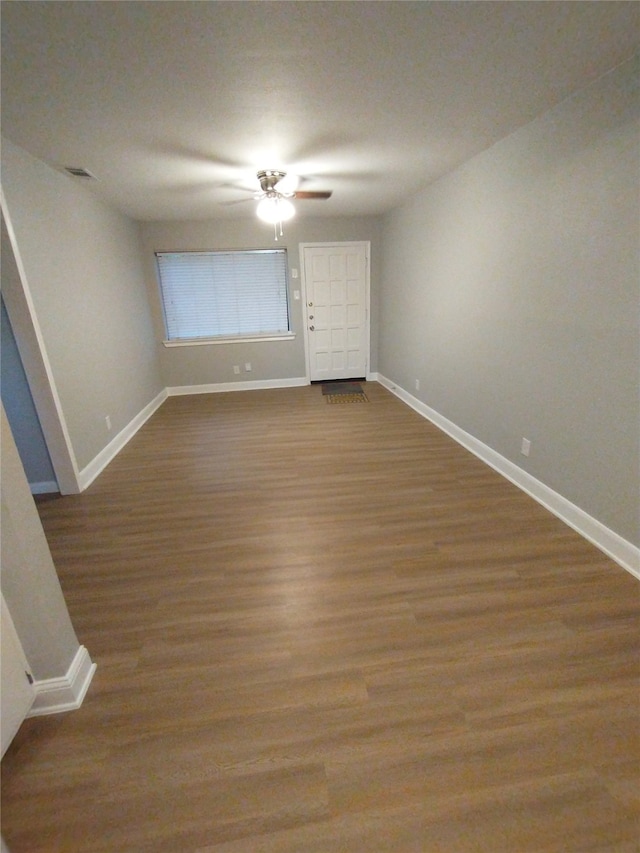 unfurnished room featuring ceiling fan and hardwood / wood-style flooring