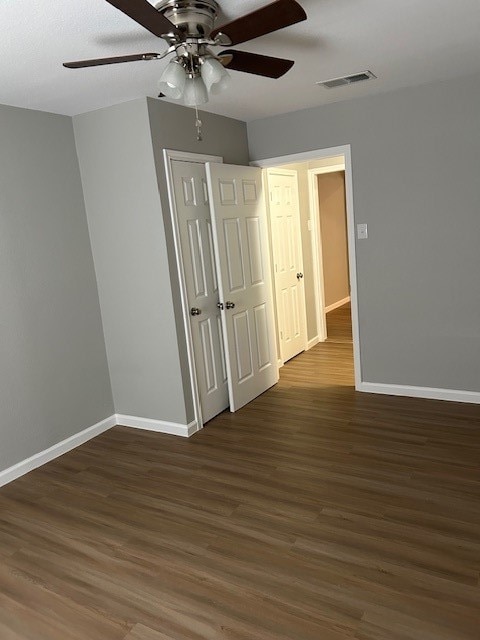 unfurnished room featuring ceiling fan and dark hardwood / wood-style floors