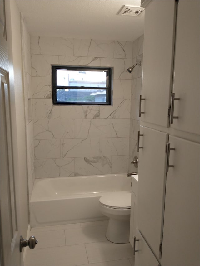 full bathroom with toilet, tile patterned flooring, vanity, and tiled shower / bath