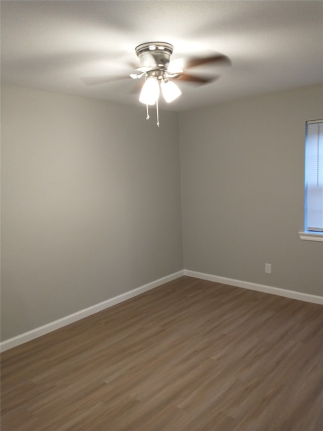 empty room featuring dark hardwood / wood-style flooring and ceiling fan