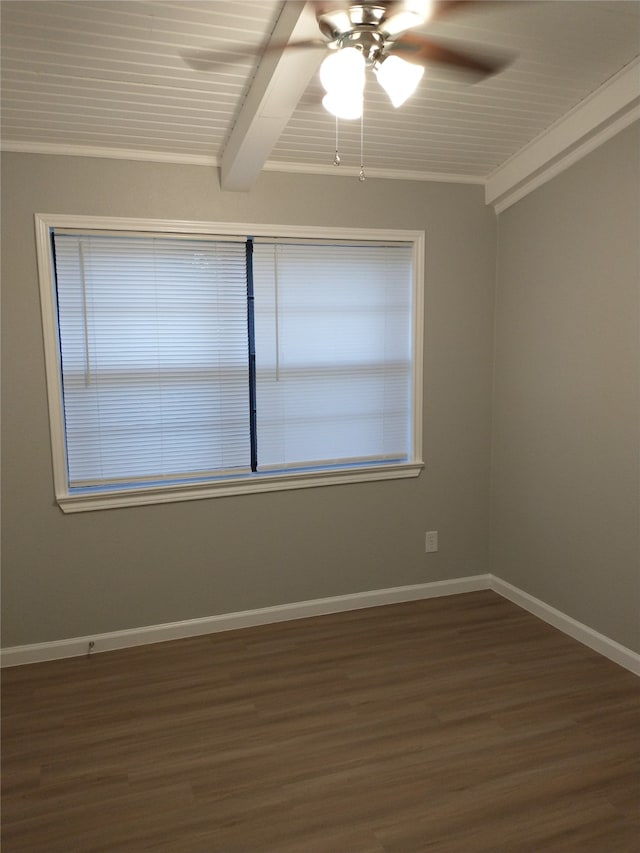 spare room with ceiling fan, beam ceiling, crown molding, and dark wood-type flooring