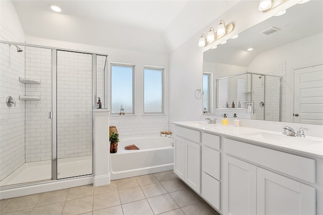 bathroom featuring tile patterned floors, vanity, plus walk in shower, and vaulted ceiling