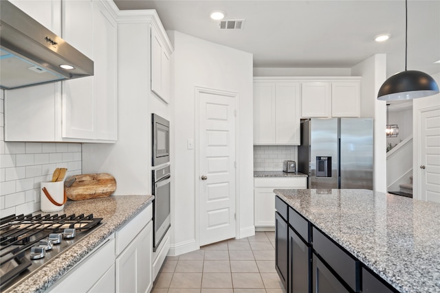 kitchen with ventilation hood, decorative light fixtures, white cabinetry, and appliances with stainless steel finishes